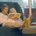 Deborah White of Little Rock reads to her daughter Aven, 5, Thursday afternoon at the Fayetteville P...