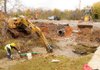 Despite light rain falling, crews continued working on the Eighth Street extension westward from its intersection with Southwest I Street in Bentonville.