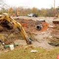 Despite light rain falling, crews continued working on the Eighth Street extension westward from its...