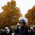 The Rogers Heritage High School band marches along South Fifth Street on Friday during the school’s ...