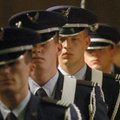 Members of the University of Arkansas Air Force ROTC exit Friday after presenting the colors at a ce...