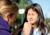 Yvette Calderon, 6, receives an intranasal swine-flu vaccine Saturday at a free drive-through clinic in The Woodlands, Texas.