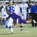 Rogers senior punter Spencer Dunlop (4) is tackled by Fayetteville junior  Colby Jordan after a botc...