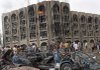Iraqis gather Sunday in Baghdad after a pair of suicide bombings targeted two government buildings, killing dozens.