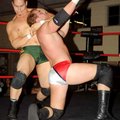 Jason Jones signaled for the referee as the Cancun Kid held him in a headlock during a Northwest Ark...