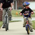 Kyle Munter, 5, of Springdale takes an afternoon bike ride Sunday with his dad Mike Munter along Wes...