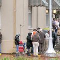 A long line of people stretched around the corner in front of the Benton County Courthouse Annex in ...