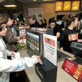 Mykenzie Melo, 11, placed her receipt into a collection box at Chick-fil-A in Bentonville on Tuesday...