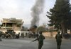 Afghan soldiers gather as smoke rises from a U.N. guest house after it was attacked by gunmen in Kabul, Afghanistan, Wednesday.