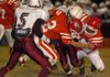 Farmington senior safety Logan Boudrey (2) and sophomore linebacker Deon Clay tackle Huntsville junior tailback Cody Wages for a loss in the first half Friday Oct. 23 at Allan Holland Field in Farmington. 