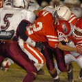 Farmington senior safety Logan Boudrey (2) and sophomore linebacker Deon Clay tackle Huntsville juni...