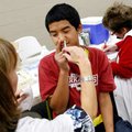 Registered nurse Monica Wittschen administers swine flu vaccine to seventh-grader Julan Langbata, 13...