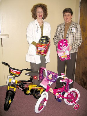Amber Doom, Hot Springs County Medical Center clinical dietitian, left, and Kim Burton, business office director, check out the two bicycles and helmets that will be given away during the Children’s Health and Safety Fair Saturday.