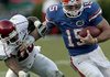 QB Tim Tebow fights off Arkansas's Ramon Broadway in the third quarter of the Razorbacks game in Florida.