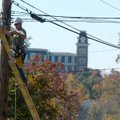 Wally Stanimirovic, customer service specialist with AT&T, finishes up work on an aerial terminal on...