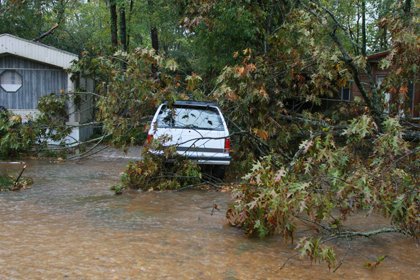 a-tree-is-down-near-a-vehicle-in-a-flooded-mobile-home-park-in-east-camden