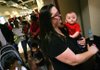 Beth Morgan of Bella Vista waits Thursday to get a swine flu vaccination for her 30-week-old son Will at the Jones Center for Families in Springdale, where the Washington County Health Unit had set up a clinic. 
