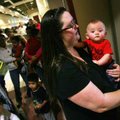 Beth Morgan of Bella Vista waits Thursday to get a swine flu vaccination for her 30-week-old son Wil...