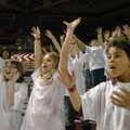 Fifth-graders Abby Wright (from left), Cassie Bryant and Jaquez Saucier cheer with their classmates ...