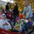 Isaac Dixon, 3, left, and Andrew Porta, 3, ride along in a wagon Friday during Trick or Treat on the...