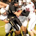 Bentonville senior Ben Nichols, No. 34, was dragged down by a trio of Springdale defenders during a ...