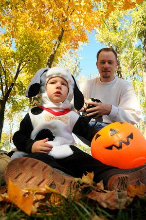 Jackson Brent, 2, attended the Howl-O-Ween dressed as a Dalmatian at Murphy Dog Park in Rogers on Saturday. At right is Jackson’s father, Michael Brent. 