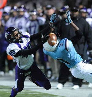 Fayetteville senior receiver Quentin Smith (49) reaches for a pass as Har-Ber senior cornerback Katraius Lane defends during the second quarter of the Dogs’ 39-14 loss Friday at Jarrell Williams Bulldog Stadium in Springdale. 