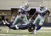 Dallas’ Felix Jones (Arkansas Razorbacks) tries break free from Seattle’s Jordan Babineaux (Southern Arkansas) on Sunday in Arlington, Texas. Jones had 114 all-purpose yards as the Cowboys won 38-17.