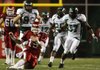 Arkansas quarterback Ryan Mallett slides after running away from Eastern Michigan defenders during a 63-27 victory Saturday. Mallett finished with 42 yards rushing.