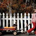 Anna Claire Lambert, 7, of Fayetteville pulls her neighborhood friend Eli Rose, 4, in a wagon in fro...