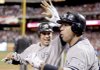 New York Yankees' Alex Rodriguez (right) is congratulated by Mark Teixeira after Rodriguez scored during the ninth inning of Game 4 of the Major League Baseball World Series against the Philadelphia Phillies. 