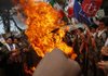 Male Iranian school students, who are members of Basij militia, which is a unit of the Revolutionary Guard, burn a US flag, in an annual demonstration in front of the former US Embassy in Tehran, Iran, Wednesday.