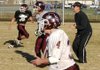 Gentry coach football Brain Little works with receivers Justin Stewart, left, Seth Kilgore, center, and Tanner Morgan during practice in Gentry on Tuesday. Gentry plays at Huntsville on Friday and can secure a berth in the Class 4A playoffs with a win.