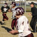 Gentry coach football Brain Little works with receivers Justin Stewart, left, Seth Kilgore, center, ...