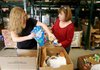 Shannan Lowe (left) and Bette Tatum, both with First Baptist Church of Lowell, select food Tuesday for the church’s food pantry inside the Northwest Arkansas Food Bank in Bethel Heights.