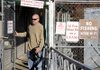 Pat LaPerre of Rogers walks out of the Prairie Creek Marina on Tuesday. The Little Rock District of the Army Corps of Engineers will begin enforcing the commercial zone policy at district marinas.