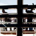 Jim Bible (left) and Don Waldo, both with Alliance Cleaning Services, clean the windows above concou...