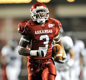 Arkansas wide receiver Joe Adams races for the end zone for a touchdown during the third quarter Saturday in Reynolds Razorback Stadium in Fayetteville.
