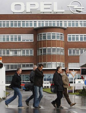 Opel employees enter the auto plant in Bochum, western Germany, on Wednesday. General Motors Co. announced Tuesday that it had decided not to sell Opel.