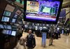 A television screen on the floor of the New York Stock Exchange announces the Federal Reserve’s decision Wednesday to hold a key interest rate at a record low.