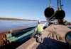 Workers unload 80-foot-long pipes, bound for a Fayetteville Shale natural-gas project, from a barge Thursday at the Little Rock Port.