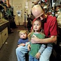 Jeff Clardy sits with grandchildren Rayley, 6, and Ace Clardy, 1, on Wednesday in the workshop of hi...