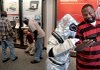 Customer service representative Leigh Merkel, dressed as a robot, promotes Verizon Wireless’ new Droid mobile phone to Myron Collins of Sherwood at a Verizon store in North Little Rock.  