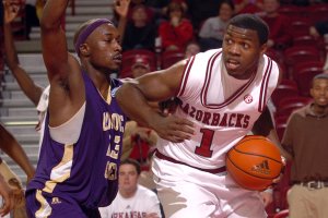 Brandon Mitchell, shown in 2009 against LeMoyne-Owen, gave up basketball to concentrate on football, but the Razorbacks’ backup quarterback decided to try basketball again after playing with old teammates and friends in Amite, La., following Arkansas’ victory in the Cotton Bowl. 