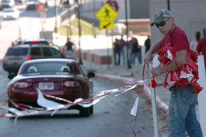 Allen Bayley, with the University of Arkansas Athletic Department, puts up a barrier around Razorback Stadium on Friday afternoon in Fayeteville as crews prepare for Arkansas game against the South Carolina Gamecocks this Saturday.
