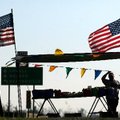 Paul Mercer of Clarksville waits for customers while selling apples Friday for White’s Produce of Pe...