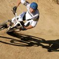 Steve Mullen leans his bicycle into the berm in speed trials for a BMX race Saturday at the Slaughte...