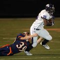 Fayetteville junior running back Dylan Hale, right, tries to escape the grasp of Rogers Heritage jun...