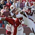 Arkansas defensive back Jerell Norton intercepts a third-quarter pass from Stephen Garcia intended f...