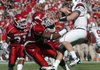 Arkansas defenders Jerico Nelson and Damario Ambrose put pressure on South Carolina quarterback Stephen Garcia in the Razorbacks’ 33-16 victory Saturday.